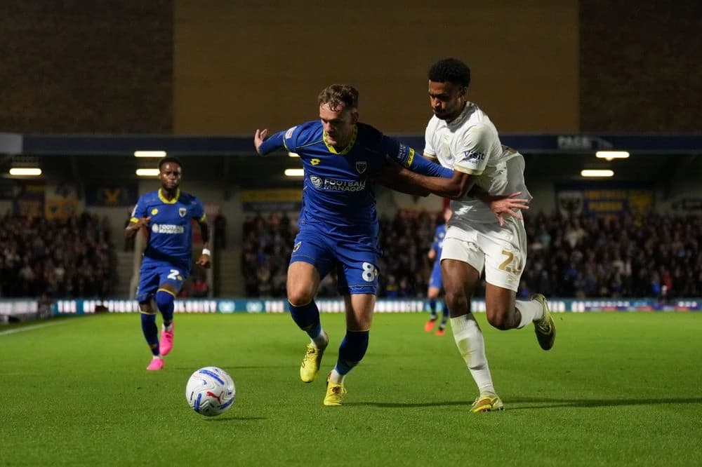 AFC Wimbledon and MK Dons share points in tense derby