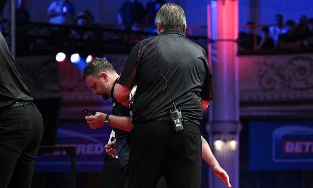 Darts star has to be helped off stage after suffering health scare during World Matchplay clash as h