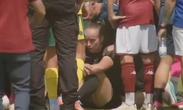 Female referee left concussed after being knocked over by brawling men's players during melee in mat