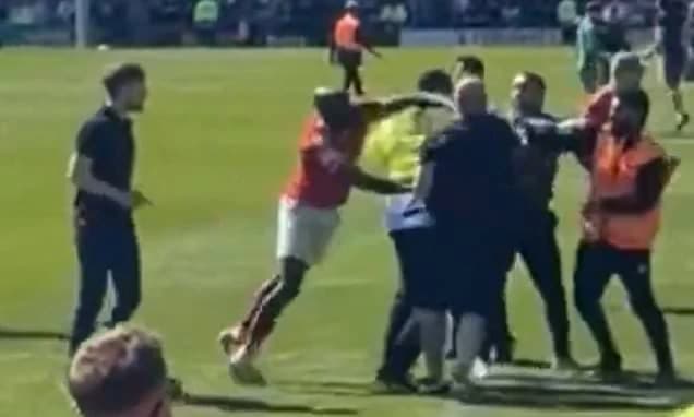 Police launch investigation after York City player PUNCHED Rochdale fan amid chaotic pitch invasion