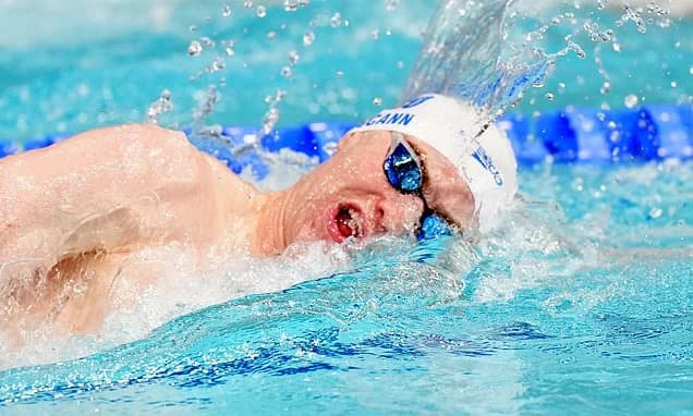 Sean McCann is cheered on by proud parents Kate and Gerry as he swims in Commonwealth 400m freestyle
